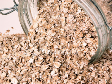 ist2_325481-container-of-spilt-raw-oats-on-table